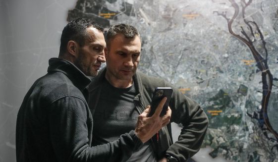 Vitali Klitschko, Kyiv Mayor and former heavyweight champion, right, and his brother Wladimir Klitschko, a Ukrainian former professional boxer look at a smart phone in the City Hall in Kyiv, Ukraine, Sunday, Feb. 27, 2022. A Ukrainian official says street fighting has broken out in Ukraine&#39;s second-largest city of Kharkiv. Russian troops also put increasing pressure on strategic ports in the country&#39;s south following a wave of attacks on airfields and fuel facilities elsewhere that appeared to mark a new phase of Russia&#39;s invasion. (AP Photo/Efrem Lukatsky) **FILE**