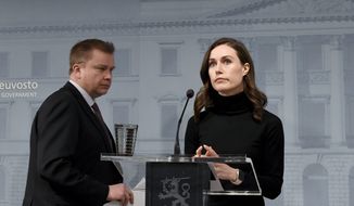 Finland&#39;s Prime Minister Sanna Marin, right, and Defence Minister Antti Kaikkonen attend a press conference of the Finnish government in Helsinki, Monday, Feb. 28, 2022. Finland has decided to deliver arms assistance to Ukraine. (Jussi Nukari/Lehtikuva via AP)