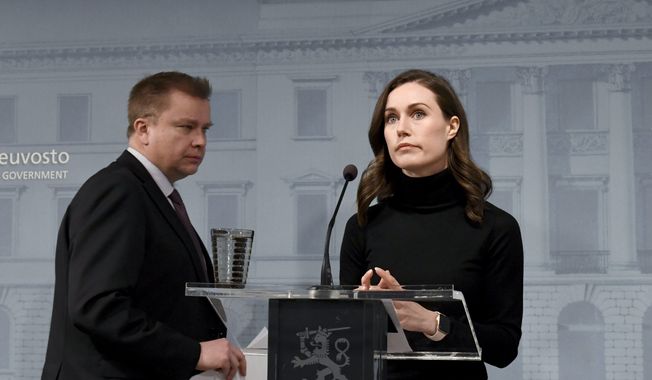 Finland&#x27;s Prime Minister Sanna Marin, right, and Defence Minister Antti Kaikkonen attend a press conference of the Finnish government in Helsinki, Monday, Feb. 28, 2022. Finland has decided to deliver arms assistance to Ukraine. (Jussi Nukari/Lehtikuva via AP)