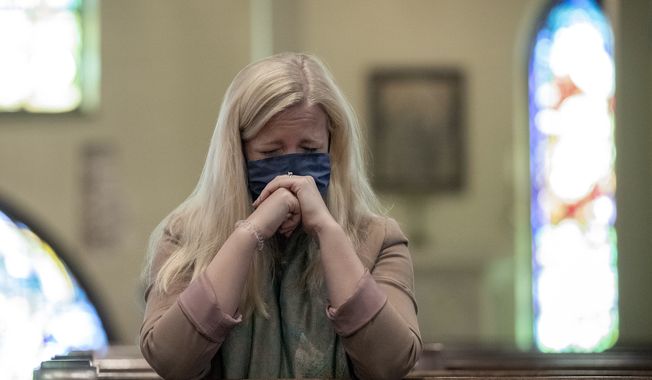 Erin Murphy prays for peace in Ukraine at St. David&#x27;s Episcopal Church in Austin, Texas, Monday, Feb. 28, 2022. The downtown church hosted the special Prayer Service for Peace In Ukraine in the wake of Russia&#x27;s attack. Murphy, who volunteered at an orphanage in Kyiv, Ukraine, for three summers, was distraught about the children who are currently sheltering underground. &quot;I have very deep connections to Ukraine,&quot; said Murphy, who also covered the 2014 conflict as a journalist. &quot;I just have a lot of people who I&#x27;m really, really worried about. I grew up in the church. I don&#x27;t know if I&#x27;m particularly religious but it&#x27;s amazing what times like these do. I know this space is sacred for me. It&#x27;s the closest sacred ground I could think of,&quot; she said. (Jay Janner/Austin American-Statesman via AP)
