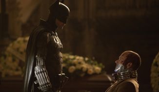 This image released by Warner Bros. Pictures shows Robert Pattinson, left, and Peter Sarsgaard in a scene from &amp;quot;The Batman.&amp;quot; (Jonathan Olley/Warner Bros. Pictures via AP)