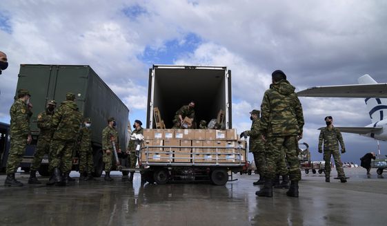 Greek soldiers prepare a plane loaded with humanitarian aid at Eleftherios Venizelos International Airport in Athens, on Sunday Feb. 27, 2022. The plane, bound for Poland, was being sent after Greece&#39;s government decided Sunday to provide humanitarian aid to Ukraine defending their country against Russia&#39;s military offensive, as well as military equipment. NATO-member Greece has traditionally friendly ties with Russia but has strongly condemned the attack ordered by Russian President Vladimir Putin. (AP Photo/Thanassis Stavrakis)
