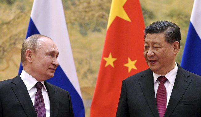 Chinese President Xi Jinping, right, and Russian President Vladimir Putin talk to each other during their meeting in Beijing, China on Feb. 4, 2022. (Alexei Druzhinin, Sputnik, Kremlin Pool Photo via AP, File)