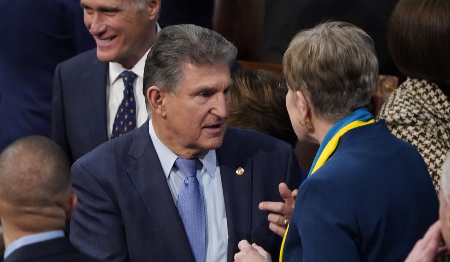Sen. Joe Manchin, D-W.Va., greets Rep. Marcy Kaptur, D-Ohio, before President Joe Biden delivers his first State of the Union address to a joint session of Congress, at the Capitol in Washington, Tuesday, March 1, 2022. Sen. Mitt Romney, R-Utah, is at back right.(AP Photo/J. Scott Applewhite, Pool)