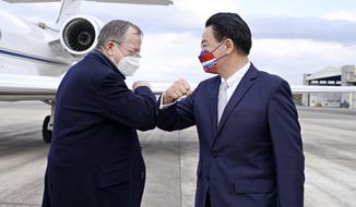 In this photo released by Taiwan&#39;s Ministry of Foreign Affairs, Taiwan&#39;s Foreign Minister Joseph Wu, right, greets former Chairman of the Joint Chiefs Adm. Mike Mullen as he arrives at Taipei Songshan Airport in Taipei, Taiwan, Tuesday, March 1, 2022. A delegation of former U.S. defense officials landed in Taiwan Tuesday in a sign of stepped-up communication between the sides amid the looming threat from China. (Taiwan Ministry of Foreign Affairs via AP)