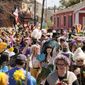 Societe de Sainte Anne parade goers march during Mardi Gras on Tuesday, March 1, 2022, in New Orleans. (AP Photo/Gerald Herbert)