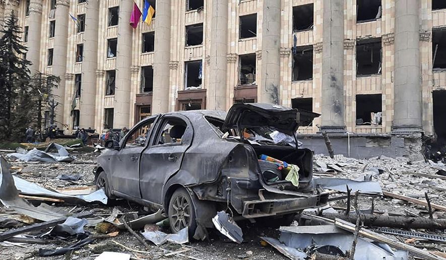 In this handout photo released by Ukrainian Emergency Service, a burnt car is seen in front of a damaged City Hall building, in Kharkiv, Ukraine, Tuesday, March 1, 2022. Russian shelling pounded civilian targets in Ukraine&#x27;s second-largest city, Kharkiv, Tuesday and a 40-mile convoy of tanks and other vehicles threatened the capital - tactics Ukraine&#x27;s embattled president said were designed to force him into concessions in Europe&#x27;s largest ground war in generations. (Ukrainian Emergency Service via AP)