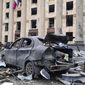 In this handout photo released by Ukrainian Emergency Service, a burnt car is seen in front of a damaged City Hall building, in Kharkiv, Ukraine, Tuesday, March 1, 2022. Russian shelling pounded civilian targets in Ukraine&#39;s second-largest city, Kharkiv, Tuesday and a 40-mile convoy of tanks and other vehicles threatened the capital - tactics Ukraine&#39;s embattled president said were designed to force him into concessions in Europe&#39;s largest ground war in generations. (Ukrainian Emergency Service via AP)