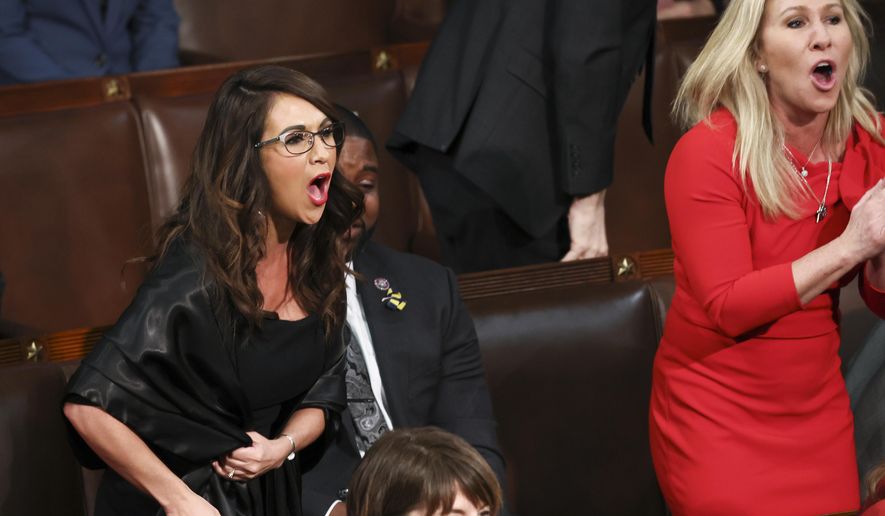 Rep. Lauren Boebert, R-Colo., left, and Rep. Marjorie Taylor Greene, R-Ga., right, scream &amp;quot;Build the Wall&amp;quot; as President Joe Biden delivers his first State of the Union address to a joint session of Congress at the Capitol, Tuesday, March 1, 2022, in Washington. (Evelyn Hockstein/Pool via AP)