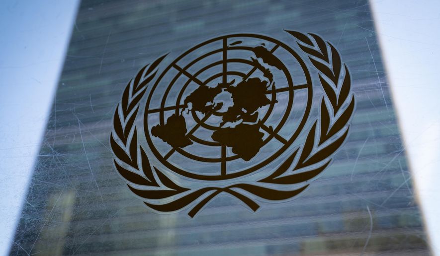 The symbol of the United Nations is displayed outside the Secretariat Building during an emergency meeting of the UN General Assembly, Monday, Feb. 28, 2022, at United Nations Headquarters. The U.N.'s two major bodies, the 193-nation General Assembly and the more powerful 15-member Security Council, are holding separate meetings Monday on Russia's invasion of Ukraine. (AP Photo/John Minchillo)