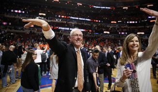 Syracuse head coach Jim Boeheim and his wife Juli wave to the fans after an NCAA college basketball game against Virginia in the regional finals of the NCAA Tournament, Sunday, March 27, 2016, in Chicago. Syracuse won 68-62. (AP Photo/Charles Rex Arbogast) **FILE**