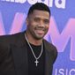 Russell Wilson arrives at the Billboard Women in Music Awards on Wednesday, March 2, 2022, at the YouTube Theater in Los Angeles. (Photo by Jordan Strauss/Invision/AP)