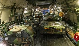 This photo provided Wednesday, March 2, 2022, by the French Army shows tanks going into a cargo plane to Romania, Tuesday, March 1, 2022, at the Istres military base, southern France. France announced last week it will deploy 500 troops with armored vehicles as part of NATO forces to Romania after Russia&#39;s invasion of neighboring Ukraine. (Etat Major des Armees via AP)