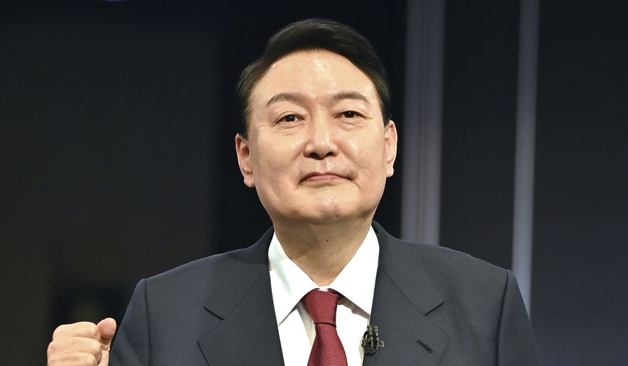 South Korea&#x27;s presidential candidate Yoon Suk-yeol of the main opposition People Power Party poses for a photo before a televised debate for the upcoming March 9 presidential election at KBS studio in Seoul on Wednesday, March 2, 2022. (Jung Yeon-je/Pool Photo via AP)