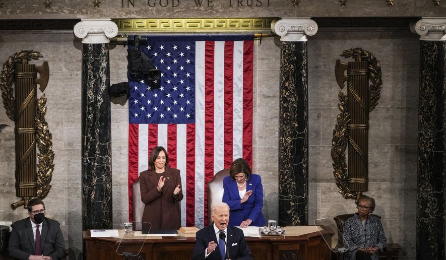 President Joe Biden delivers his first State of the Union address to a joint session of Congress at the Capitol, Tuesday, March 1, 2022, in Washington as Vice President Kamala Harris applauds and House speaker Nancy Pelosi of Calif., looks on. (Sarahbeth Maney/The New York Times via AP, Pool)