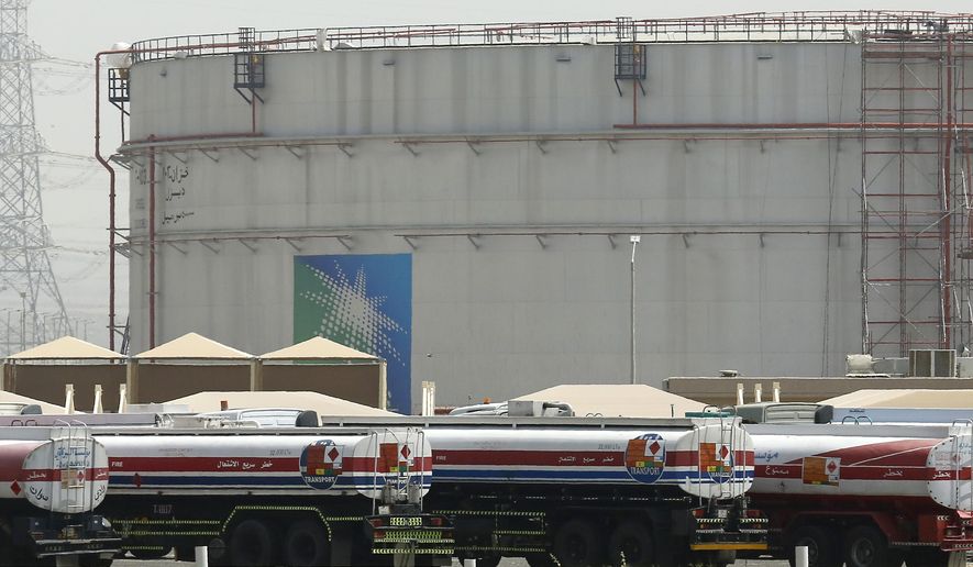 Fuel trucks line up in front of storage tanks at the North Jiddah bulk plant, an Aramco oil facility, in Jiddah, Saudi Arabia, on March 21, 2021. (AP Photo/Amr Nabil, File)