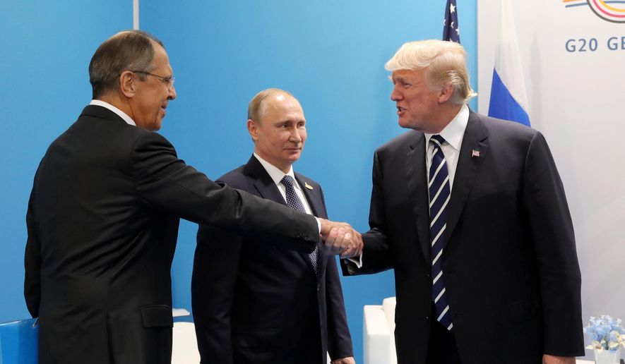 In this file photo, U.S. President Donald Trump (right) greets Russian Foreign Minister Sergey Lavrov (left) prior to his talks with Russian President Vladimir Putin (center) during the G-20 summit in Hamburg, Germany, on July 7, 2017. (Mikhail Klimentyev, Kremlin Pool Photo via AP) **FILE**