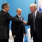 in this file photo, U.S. President Donald Trump, right, greets Russian Foreign Minister Sergey Lavrov, left, prior to his talks with Russian President Vladimir Putin, center, during the G-20 summit in Hamburg Germany in July 7, 2017.  (Mikhail Klimentyev, Kremlin Pool Photo via AP, File)