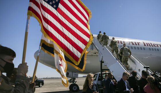 More than 180 soldiers with the U.S. Army 3rd Infantry Division, 1st Armored Brigade Combat Team climb the stairs to a charter airplane at Hunter Army Airfield during their deployment to Germany, Wednesday, March 2, 2022, in Savannah, Ga. The division sent 3,800 troops as reinforcements for various NATO allies in Eastern Europe. (Stephen B. Morton /Atlanta Journal-Constitution via AP) ** FILE **