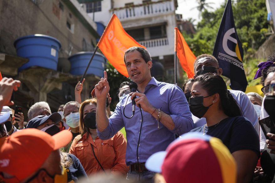 Venezuela opposition leader Juan Guaido speaks to residents to present his unity plan to Venezuelans, in Maiquetia, Venezuela, Saturday, Feb. 19, 2022. “For us, doing politics today in Venezuela is like doing politics in any country 100 years ago,” Guaido said in an interview earlier in the week. “We have to go one by one, house by house, assemblies, organization, political events that communicate for us, not the other way around.” (AP Photo/Matias Delacroix)
