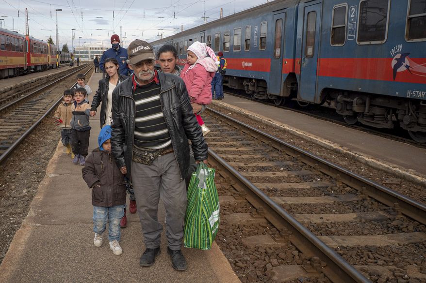 Refugees fleeing the war from neighboring Ukraine walk on a platform after disembarking from a train in Zahony, Hungary, Wednesday, March 2, 2022. Russian and Ukrainian officials agreed Thursday to establish a humanitarian corridor inside Ukraine to evacuate civilians from combat zones. (AP Photo/Balazs Kaufmann)