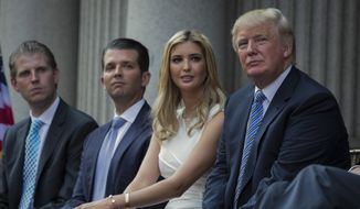 Donald Trump, right, sits with his children, from left, Eric Trump, Donald Trump Jr. and Ivanka Trump during a groundbreaking ceremony for the Trump International Hotel in Washington, July 23, 2014. (AP Photo/Evan Vucci, File)