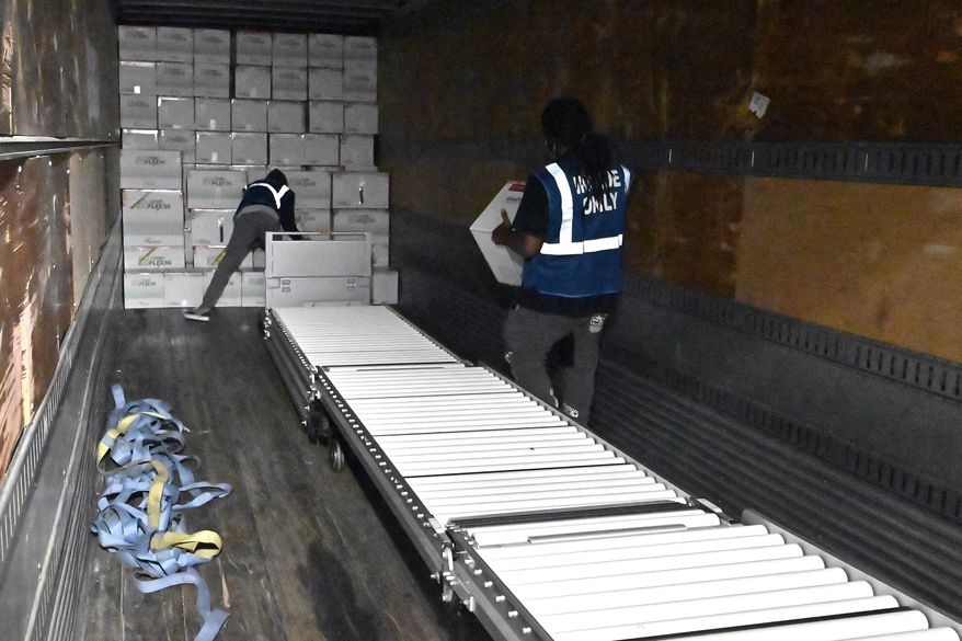 The first boxes of the Johnson & Johnson COVID-19 vaccine are loaded into a truck for shipment from the McKesson facility in Shepherdsville, Ky., Monday, March 1, 2021. As demand for COVID-19 vaccines collapses in many areas of the U.S., states are scrambling to use stockpiles of doses before they expire and have to be added to the millions that have already gone to waste. (AP Photo/Timothy D. Easley, Pool, File)