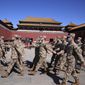 Chinese military personnel walk in formation outside the entrance to the Forbidden City in Beijing, Saturday, March 5, 2022. China is raising its defense spending in 2022 by 7.1% to $229 billion, up from a 6.8% increase the year before. (AP Photo/Ng Han Guan)