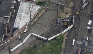 In this Wednesday, May 13, 2015, file photo, emergency personnel work at the scene of a derailment in Philadelphia of an Amtrak train headed to New York. A Philadelphia jury is expected weigh criminal charges Friday, March 4, 2022, against Amtrak engineer Brandon Bostian over the deadly derailment. (AP Photo/Patrick Semansky, File)