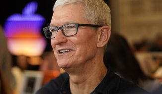 Apple CEO Tim Cook smiles as he opens the Apple Tower Theatre flagship retail store on Broadway Theatre District downtown Los Angeles Thursday, June 24, 2021. Apple&#39;s shareholders have approved a proposal Friday, March 4, 2022, urging the iPhone maker to undergo an independent audit assessing its treatment of female and minority employees, delivering a rare rebuke to a management team that runs the world&#39;s most valuable company. (AP Photo/Damian Dovarganes, File)