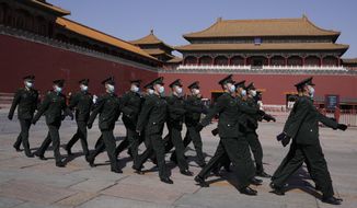 Chinese soldiers march past the Forbidden City on Friday, March 4, 2022, in Beijing. As China&#39;s 3,000-member ceremonial parliament prepare to open its annual session Saturday, March 5, 20222, China&#39;s defense budget, largely oriented toward possible military action in Taiwan, is another marquee item that is scrutinized closely by Congress watchers. (AP Photo/Ng Han Guan)