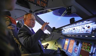 Russian President Vladimir Putin sits in the cockpit of an airplane simulator as he visits to Aeroflot Aviation School outside Moscow, Russia, Saturday, March 5, 2022. (Sputnik, Kremlin Pool Photo via AP)