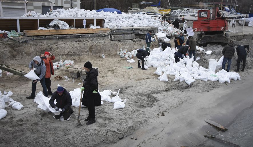 Volunteers fill sandbags to build barricades in Odesa, Ukraine, Saturday, March 5, 2022. Ukrainian forces were defending Odesa, Ukraines biggest port city, from repeated attempts by Russian ships, Ukrainian presidential adviser Oleksiy Arestovich said. (AP Photo/Max Pshybyshevsky)