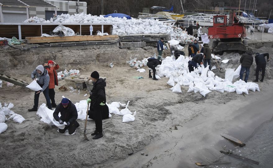 Volunteers fill sandbags to build barricades in Odesa, Ukraine, Saturday, March 5, 2022. Ukrainian forces were defending Odesa, Ukraines biggest port city, from repeated attempts by Russian ships, Ukrainian presidential adviser Oleksiy Arestovich said. (AP Photo/Max Pshybyshevsky)