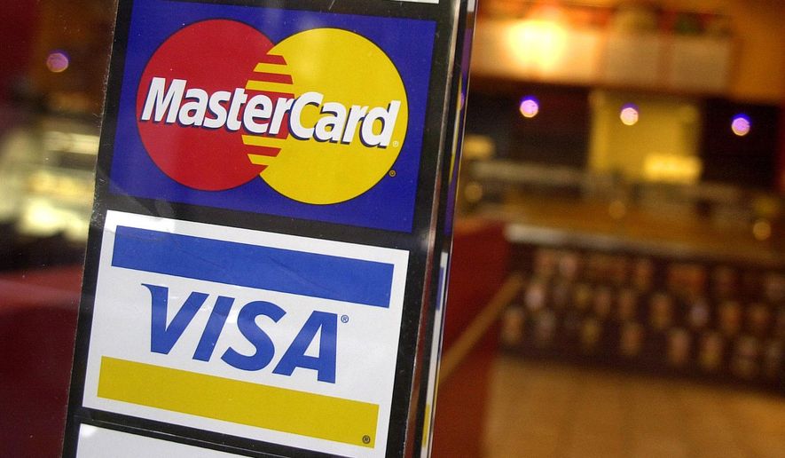 This April 22, 2005, file photo, shows logos for MasterCard and Visa credit cards at the entrance of a New York coffee shop. (AP Photo/Mark Lennihan, File)