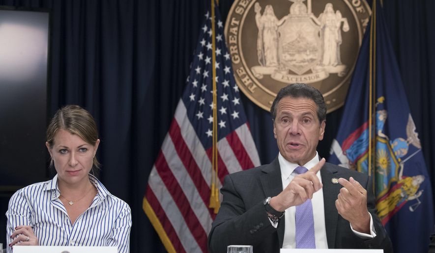 Secretary to the Governor Melissa DeRosa, left, joins New York Gov. Andrew Cuomo as he speaks to reporters during a news conference on Sept. 14, 2018, in New York. A New York state trooper who testified that former Gov. Andrew Cuomo sexually harassed her filed a lawsuit Thursday, Feb. 17, 2022, and asked a federal court to declare that Cuomo, a top aide and state police violated her civil rights. The trooper, whose name was not disclosed in the lawsuit, filed the suit in Manhattan against Cuomo, New York State Police and Cuomo&#39;s former top aide Melissa DeRosa.(AP Photo/Mary Altaffer, File)