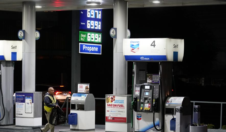 An attendant walks past a pump at a station selling gas at more than $6 a gallon, Monday, March 7, 2022, in Los Angeles. (AP Photo/Marcio Jose Sanchez)