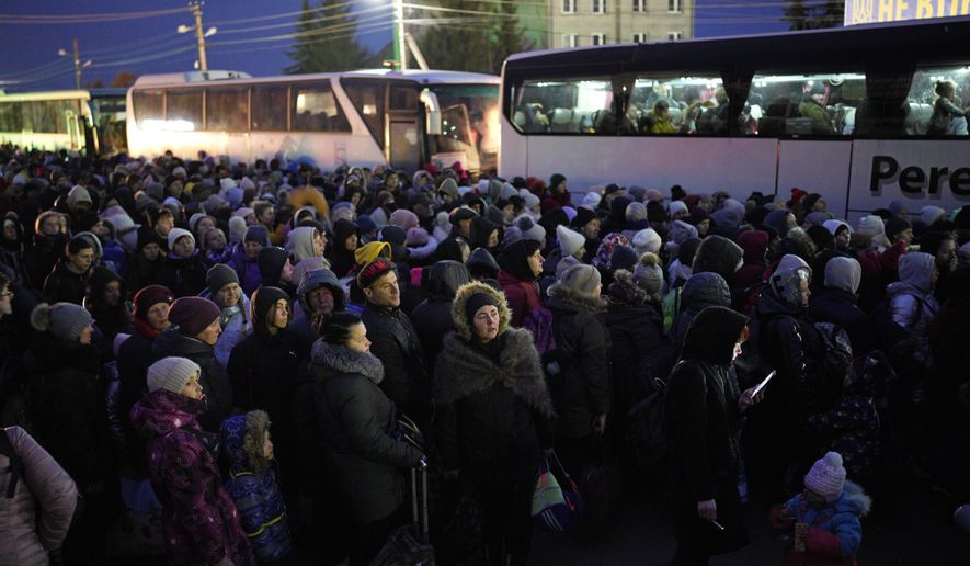 Refugees fleeing the war in Ukraine, form a line as they approach the border with Poland in Shehyni, Ukraine, Sunday, March 6, 2022. The number of Ukrainians forced from their country increased to 1.5 million and the Kremlin&#39;s rhetoric grew, with Russian President Vladimir Putin warning that Ukrainian statehood is in jeopardy. (AP Photo/Daniel Cole)
