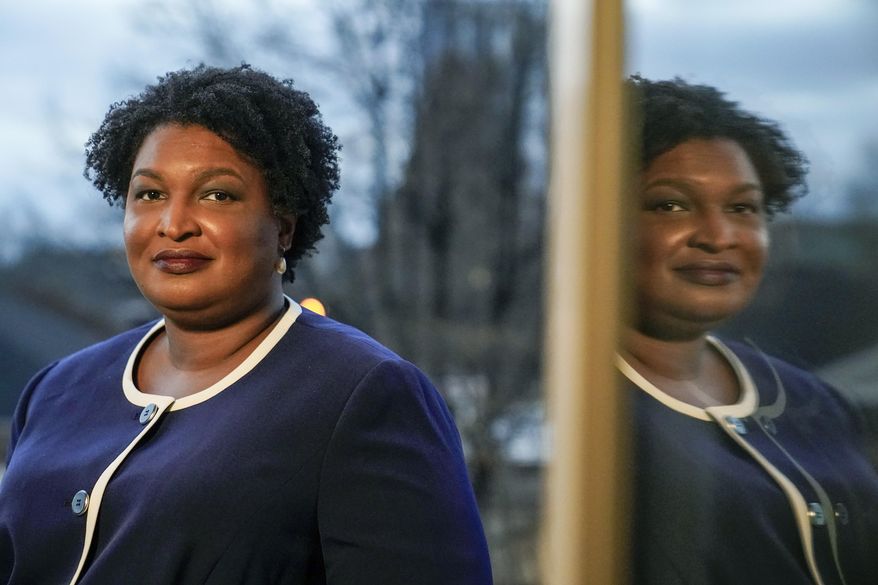 Georgia gubernatorial Democratic candidate Stacey Abrams poses for a photo during an interview with The Associated Press on Dec. 16, 2021, in Decatur, Ga. (AP Photo/Brynn Anderson, File)