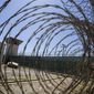 In this April 17, 2019, photo, reviewed by U.S. military officials, the control tower is seen through the razor wire inside the Camp VI detention facility in Guantanamo Bay Naval Base, Cuba. (AP Photo/Alex Brandon, File)