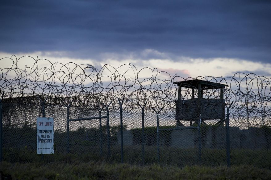 In this photo reviewed by U.S. military officials, the sun sets behind the closed Camp X-Ray detention facility, on April 17, 2019, in Guantanamo Bay Naval Base, Cuba. A Saudi prisoner at the Guantanamo Bay detention center who was suspected of trying to join the 9/11 hijackers has been sent back to his home country for treatment for mental illness. The Department of Defense says Mohammad Ahmad al-Qahtani was flown back to Saudi Arabia from the U.S. base in Cuba after a review board concluded he could be safely released after 20 years in custody. (AP Photo/Alex Brandon, File)