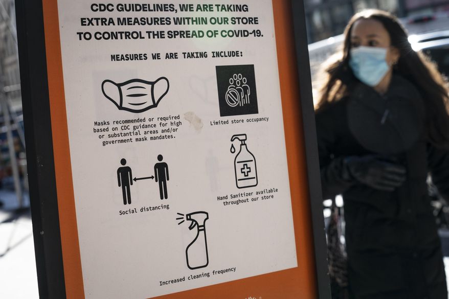In this file photo, pedestrians wearing protective masks walk along Broadway in the SoHo district of New York City, Friday, March 4, 2022. With COVID-19 cases on the rise in the Big Apple, the New York Department of Health tweeted out an advisory July 8 requesting that “all New Yorkers should wear a high-quality mask... in all public indoor settings and around crowds outside” to help slow the spread of the disease. (AP Photo/John Minchillo)