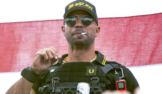In this Sept. 26, 2020, file photo, Proud Boys leader Henry &quot;Enrique&quot; Tarrio wears a hat that says The War Boys during a rally in Portland, Ore.  The leader of the far-right Proud Boys extremist group, Tarrio, was arrested Tuesday on a conspiracy charge for his suspected role in a coordinated attack on the U.S. Capitol to stop Congress from certifying President Joe Biden’s 2020 electoral victory. (AP Photo/Allison Dinner, File)