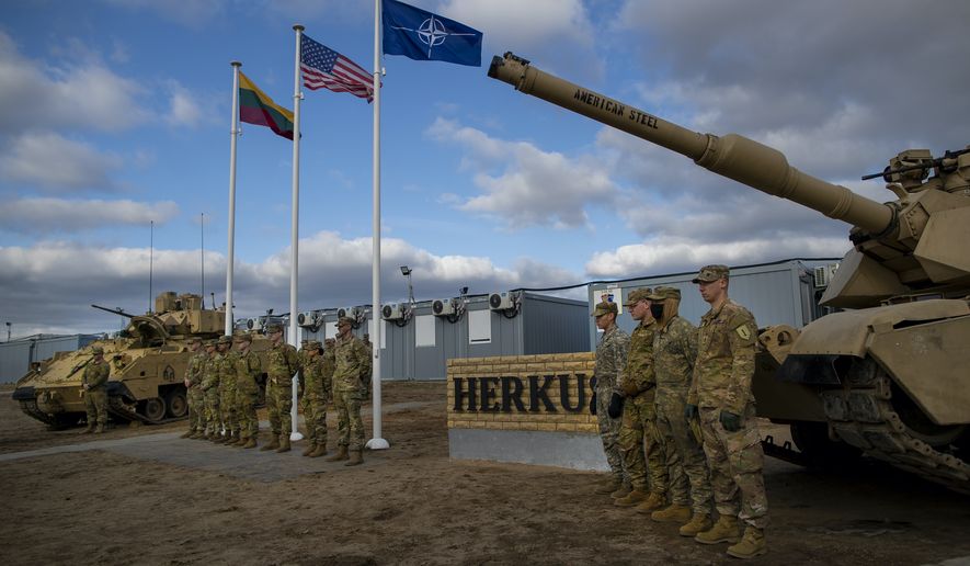 Soldiers of U.S. Army waits to greet Chairman of the Joint Chiefs of Staff Gen. Mark Milley upon his arrival at the Training Range in Pabrade, some 60km.(38 miles) north of the capital Vilnius, Lithuania, Sunday, March 6, 2022. (AP Photo/Mindaugas Kulbis)