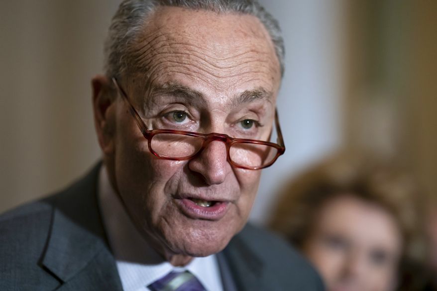 Senate Majority Leader Chuck Schumer, D-N.Y., speaks to reporters about the Russian invasion of Ukraine following a Democratic strategy meeting at the Capitol in Washington, Tuesday, March 8, 2022. (AP Photo/J. Scott Applewhite)