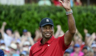 Tiger Woods celebrates on the 18th green after wining the Tour Championship golf tournament Sunday, Sept. 23, 2018, in Atlanta. Woods will be the star attraction in the World Golf Hall of Fame induction ceremony Wednesday, March 9, 2022. (AP Photo/John Amis, File) **FILE**