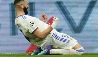 Real Madrid&#39;s Karim Benzema celebrates scoring his side&#39;s third goal during the Champions League, round of 16, second leg soccer match between Real Madrid and Paris Saint-Germain at the Santiago Bernabeu stadium in Madrid, Spain, Wednesday, March 9, 2022. (AP Photo/Manu Fernandez)