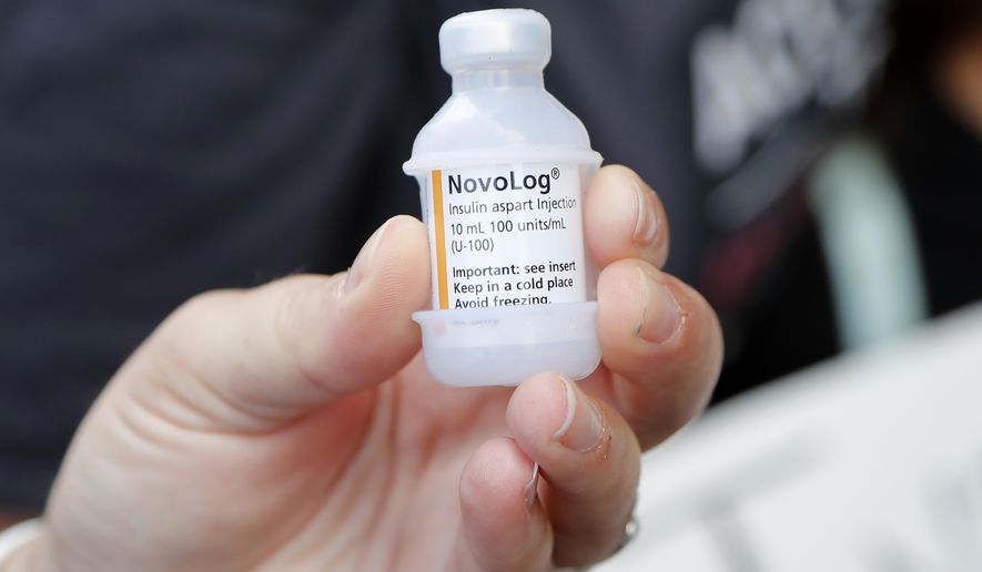 A patient holds a vial of insulin during a news conference outside the Olde Walkersville Pharmacy, July 28, 2019, in Windsor, Canada. Legislation to limit insulin costs for people with diabetes is getting a new push in the Senate. Democrats say they want to move quickly, but they&#39;ll need Republican support to get anything through an evenly divided chamber. (AP Photo/Carlos Osorio, File)
