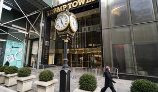 A pedestrian passes security barricades in front of Trump Tower, Feb. 17, 2021, in New York.  Donald Trump&#39;s company has secured a loan for its Trump Tower in New York despite banks cutting ties with it a year ago, the latest of several financial wins for the ex-president suggesting he might buck a business backlash following Capitol riots. (AP Photo/John Minchillo, File)