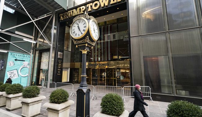 A pedestrian passes security barricades in front of Trump Tower, Feb. 17, 2021, in New York.  Donald Trump&#x27;s company has secured a loan for its Trump Tower in New York despite banks cutting ties with it a year ago, the latest of several financial wins for the ex-president suggesting he might buck a business backlash following Capitol riots. (AP Photo/John Minchillo, File)